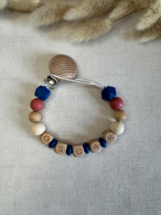 Attache tétine bleu foncé, rouge, beige